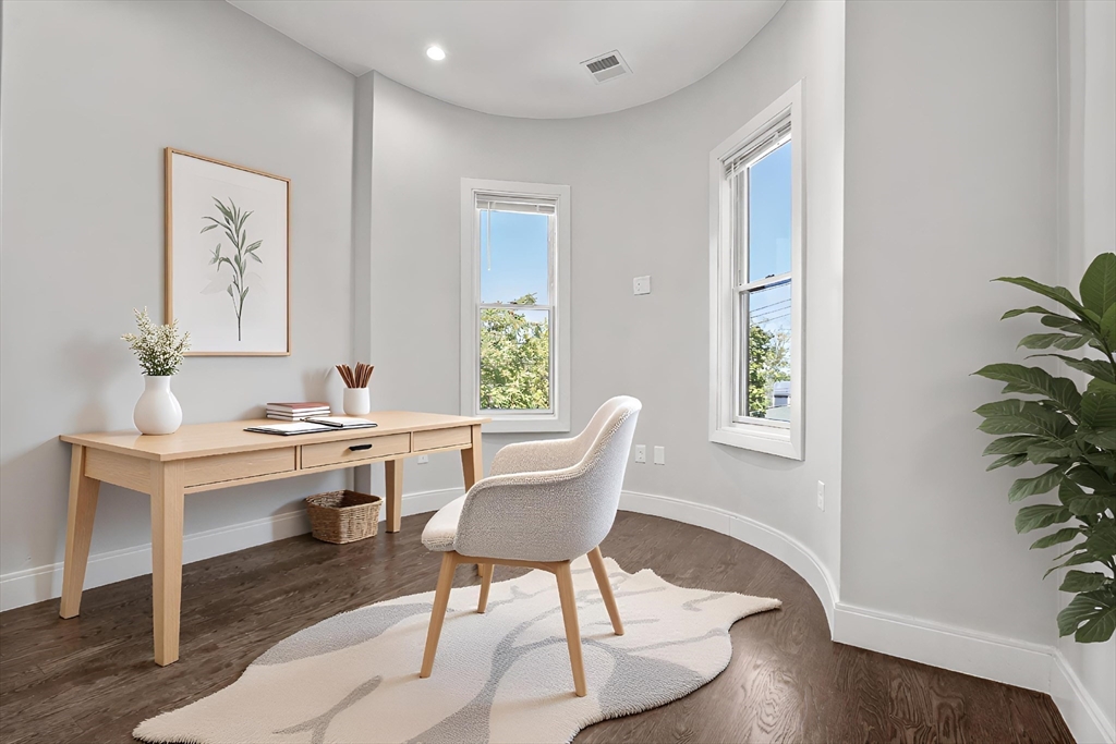 7 Langford Park, Unit 3 Boston, MA 02119 - Photo 7 of 16 a view of a work space with furniture and wooden floor