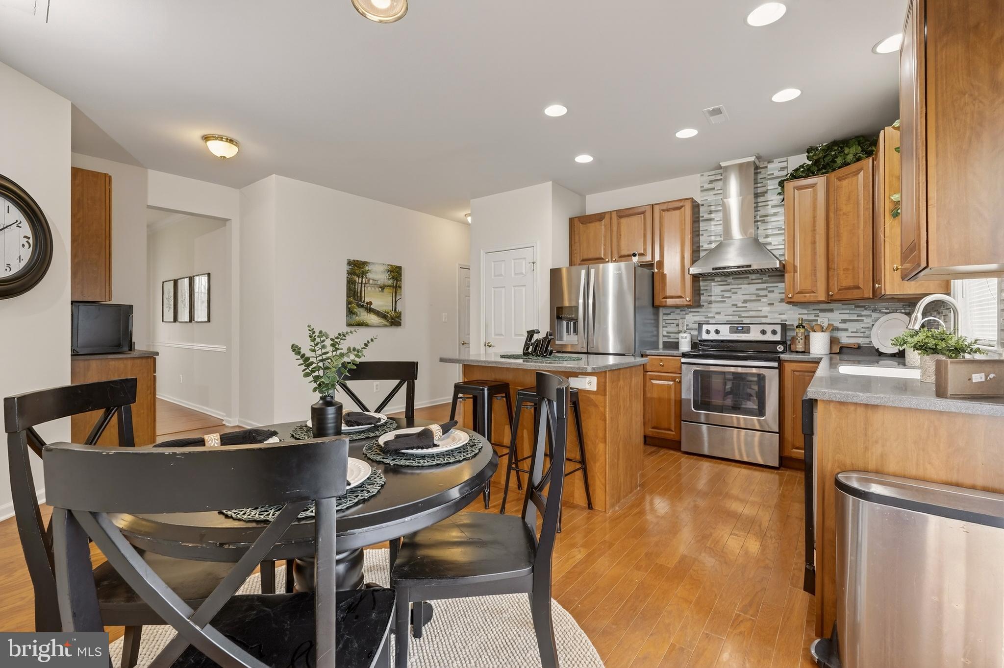 169 Thomas Jefferson Terrace Elkton, MD 21921 - Photo 22 of 64 a kitchen with stainless steel appliances granite countertop a sink a stove a refrigerator cabinets and chairs