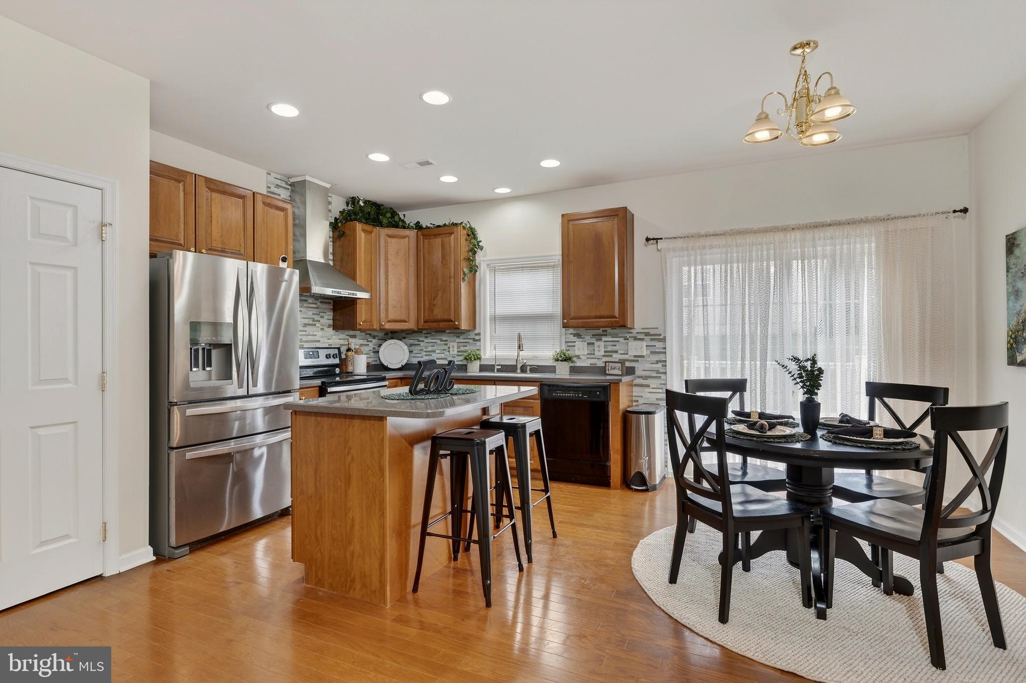 169 Thomas Jefferson Terrace Elkton, MD 21921 - Photo 25 of 64 a kitchen with stainless steel appliances kitchen island granite countertop a dining table chairs and granite counter tops