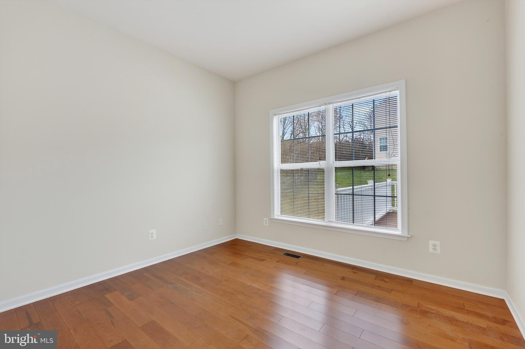 169 Thomas Jefferson Terrace Elkton, MD 21921 - Photo 27 of 64 an empty room with wooden floor and windows