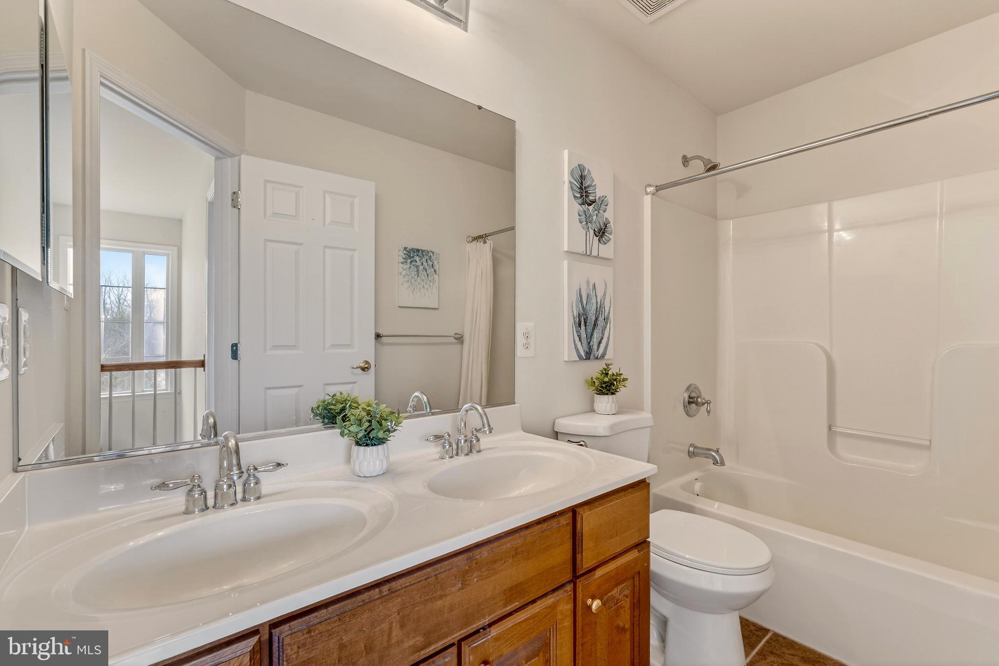 169 Thomas Jefferson Terrace Elkton, MD 21921 - Photo 34 of 64 a bathroom with a granite countertop sink toilet a large mirror a shower and a bathtub