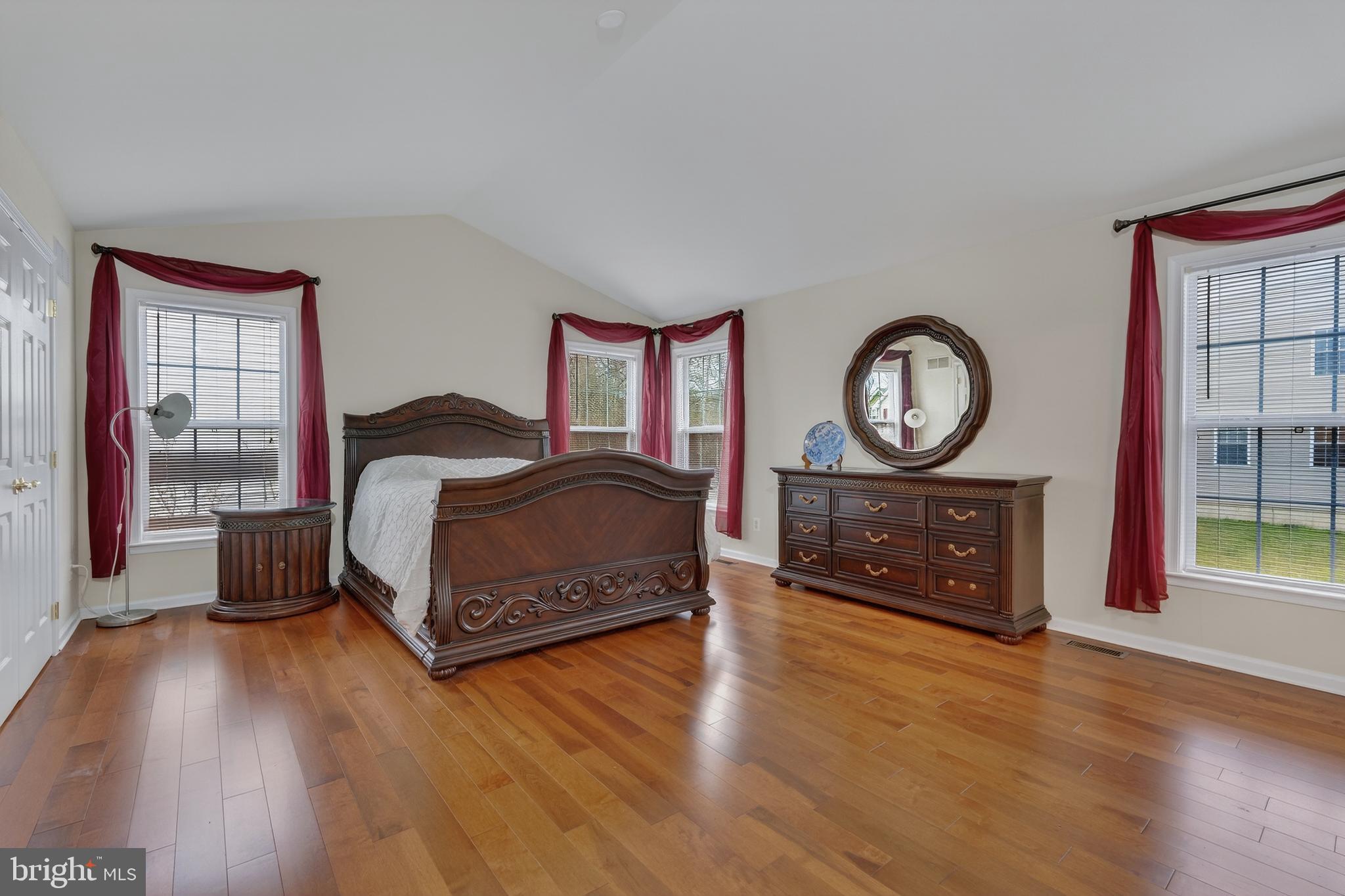 169 Thomas Jefferson Terrace Elkton, MD 21921 - Photo 40 of 64 a bedroom with a bed a mirror on dresser and a large window