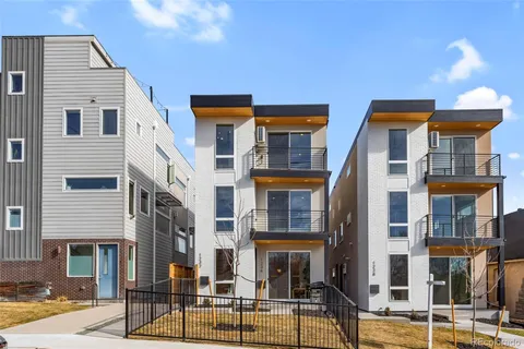 a front view of a residential apartment building with a yard