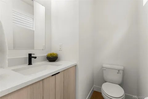 a bedroom with a large bed and a lamp