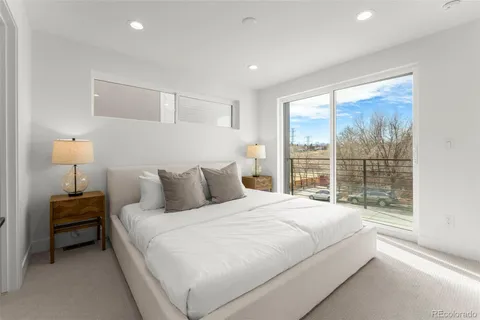 a bed sitting in a bedroom next to a window