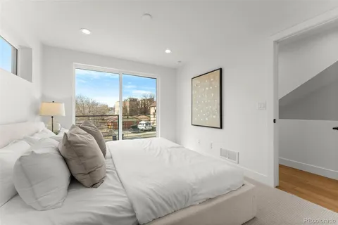 a bedroom with a bed and a lamp