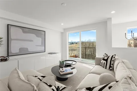 a living room with furniture and a floor to ceiling window