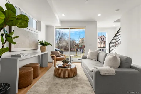 a living room with furniture and a potted plant