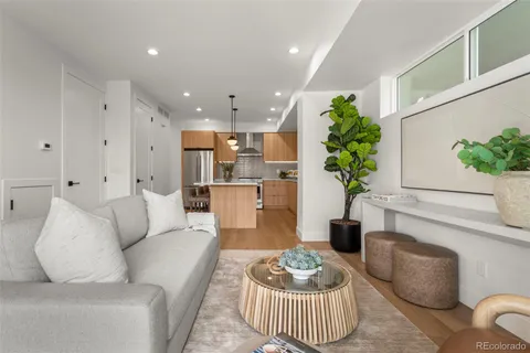 a kitchen with stainless steel appliances granite countertop a sink a stove a refrigerator and island