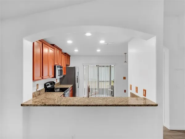 a view of a kitchen with granite countertop a sink and a granite counter top