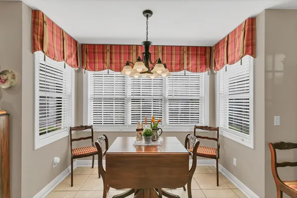 a dining room with furniture and window