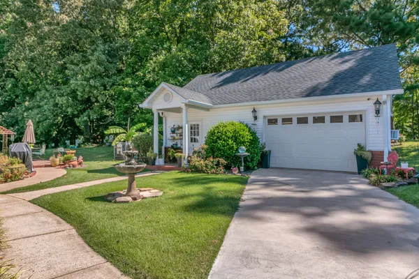 a front view of a house with a yard and a garage