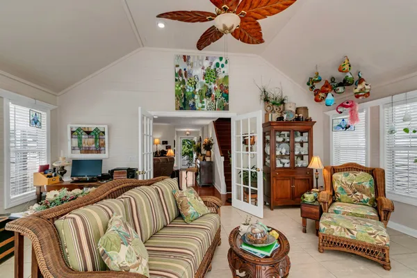 a living room with furniture and a chandelier
