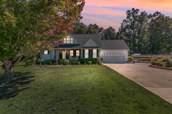 a front view of a house with a garden