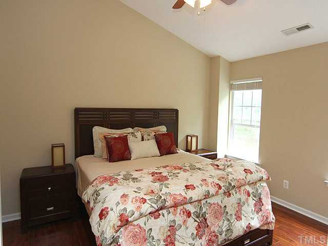 1127 Lake Moraine Place Raleigh, NC 27607 - Photo 12 of 23 a bedroom with a bed and a window