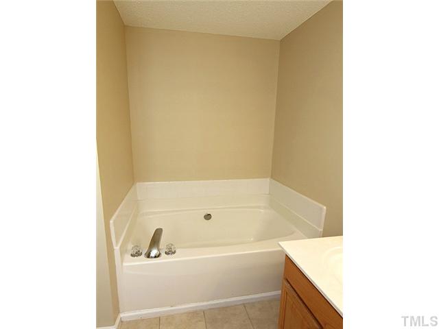 1127 Lake Moraine Place Raleigh, NC 27607 - Photo 16 of 23 a white bath tub sitting next to a white sink