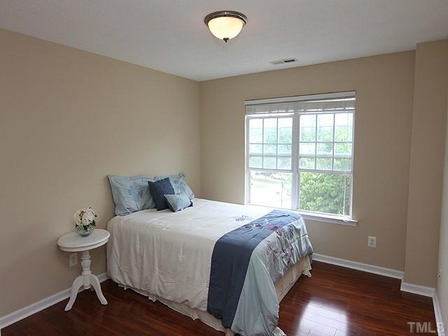 1127 Lake Moraine Place Raleigh, NC 27607 - Photo 17 of 23 a bedroom with a bed and a window