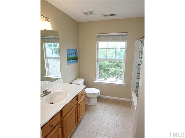 1127 Lake Moraine Place Raleigh, NC 27607 - Photo 18 of 23 a spacious bathroom with a granite countertop sink a toilet and a window