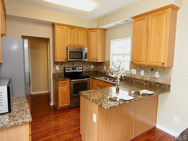 1127 Lake Moraine Place Raleigh, NC 27607 - Photo 8 of 23 a kitchen with a sink appliances and cabinets