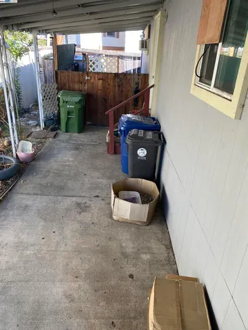 a room with wooden floor and outdoor seating