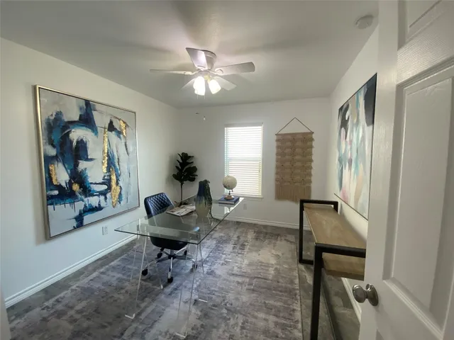 a living room with furniture and a painting on the wall