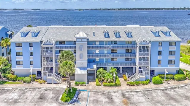 a front view of a building with garden and seating area