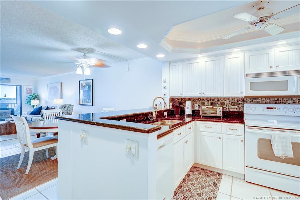 10 Northeast Plantation Road, Unit 203 Stuart, FL 34996 - Photo 13 of 50 a kitchen that has a sink and a stove in it