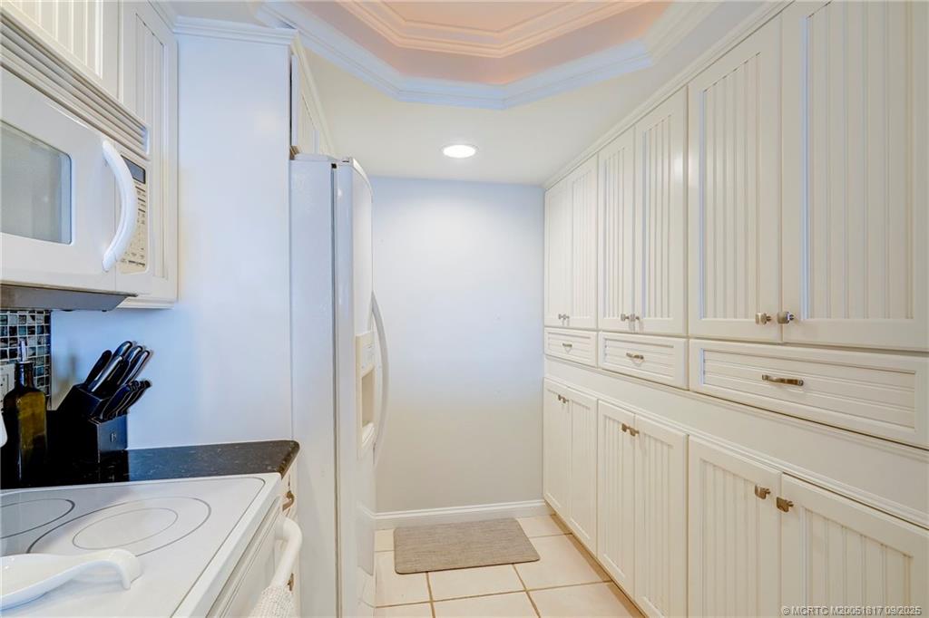 10 Northeast Plantation Road, Unit 203 Stuart, FL 34996 - Photo 16 of 50 a kitchen with white cabinets and a sink