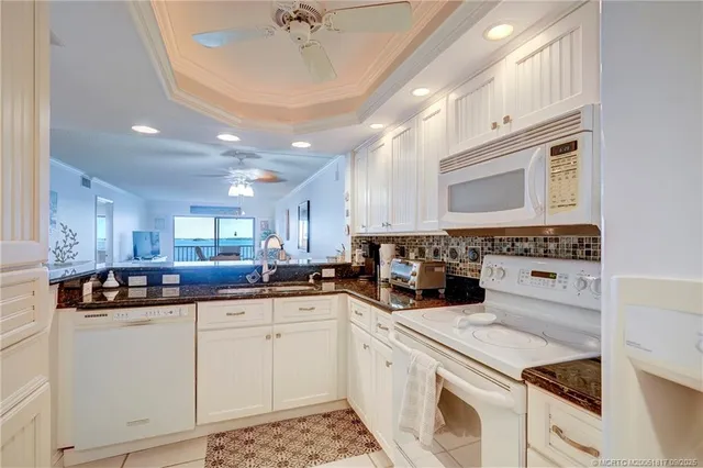 a bathroom with a granite countertop sink a toilet and a mirror