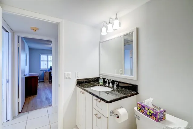 a bedroom with a bed wooden floor and window