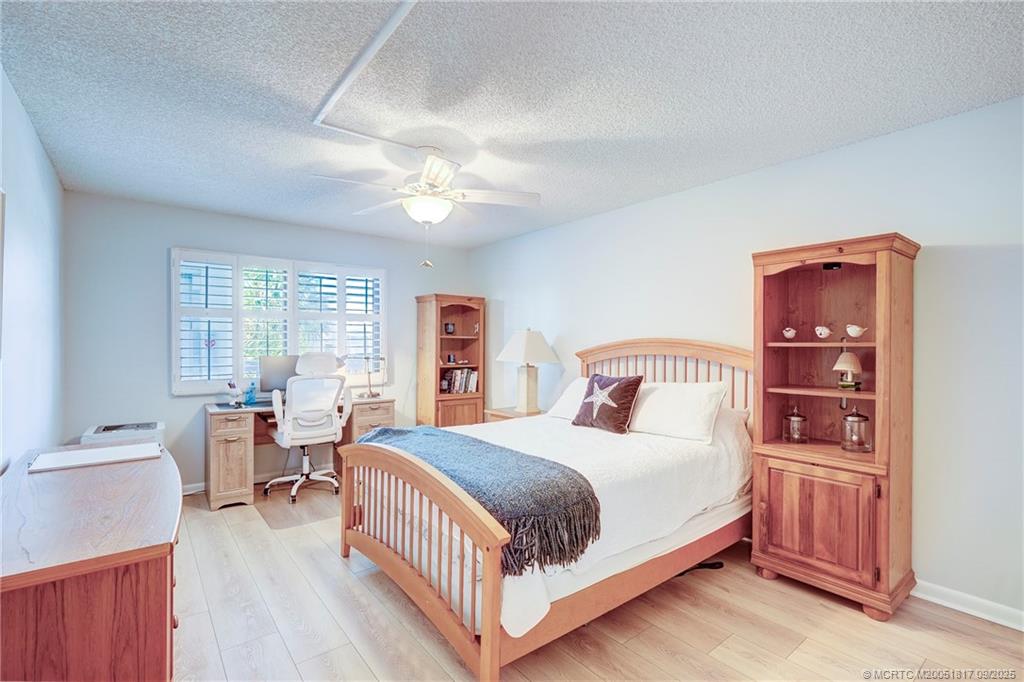 10 Northeast Plantation Road, Unit 203 Stuart, FL 34996 - Photo 20 of 50 a bedroom with a bed wooden floor and window