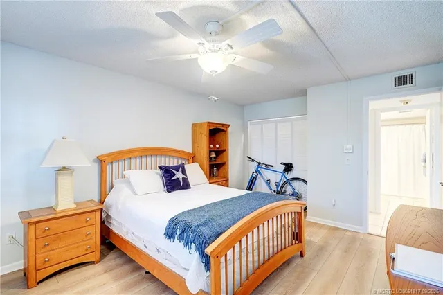 a bedroom with a bed window and a chair