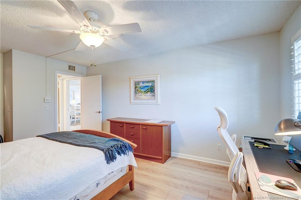 10 Northeast Plantation Road, Unit 203 Stuart, FL 34996 - Photo 23 of 50 a bedroom with a bed window and a chair