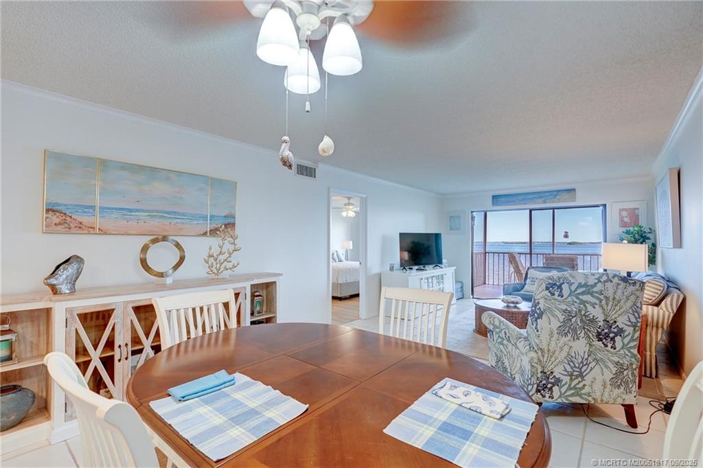 10 Northeast Plantation Road, Unit 203 Stuart, FL 34996 - Photo 25 of 50 a living room with furniture and a wooden floor