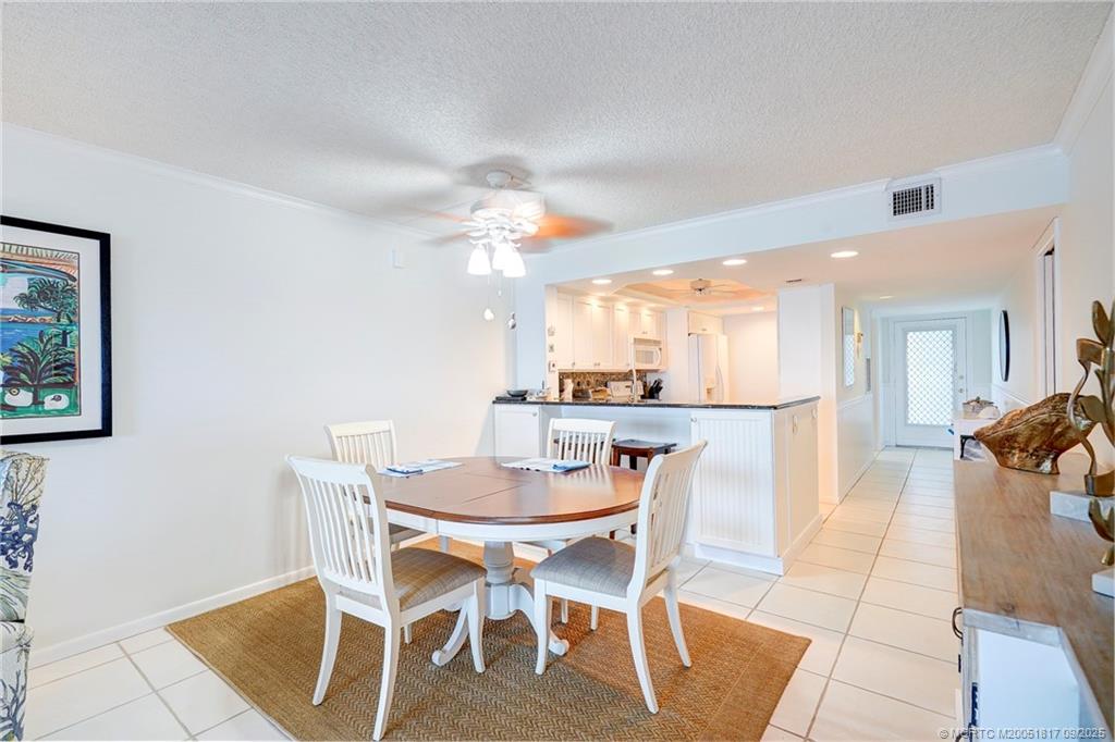 10 Northeast Plantation Road, Unit 203 Stuart, FL 34996 - Photo 26 of 50 a view of a dining room with furniture and wooden floor