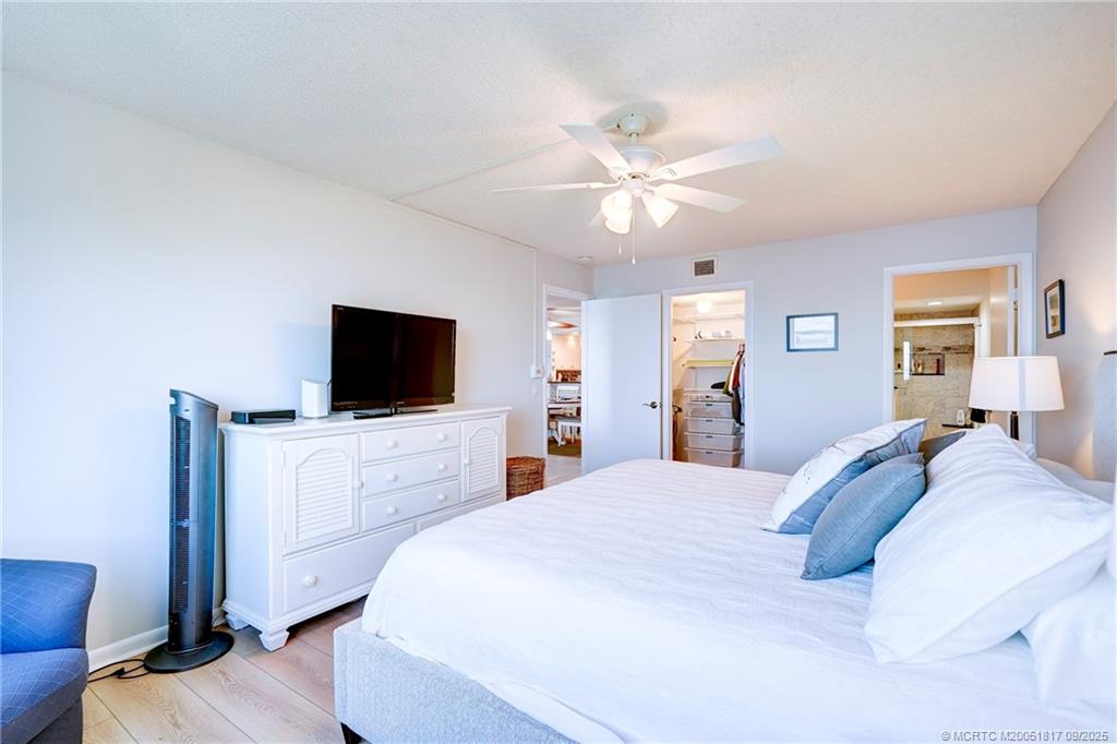 10 Northeast Plantation Road, Unit 203 Stuart, FL 34996 - Photo 36 of 50 a bedroom with a bed and a flat screen tv