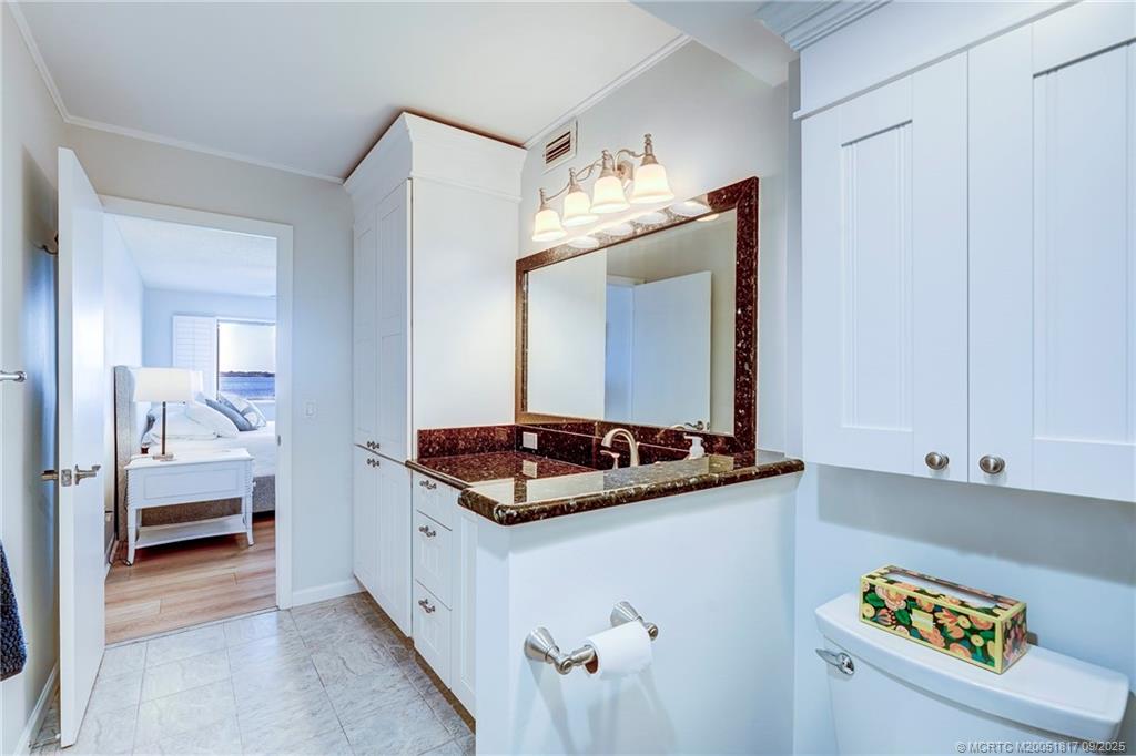 10 Northeast Plantation Road, Unit 203 Stuart, FL 34996 - Photo 39 of 50 a en suite bathroom with a sink and a mirror