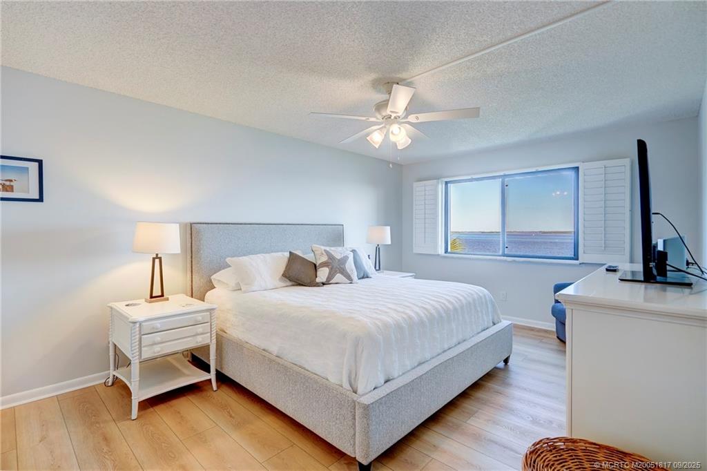 10 Northeast Plantation Road, Unit 203 Stuart, FL 34996 - Photo 44 of 50 a bedroom with a bed and a flat screen tv