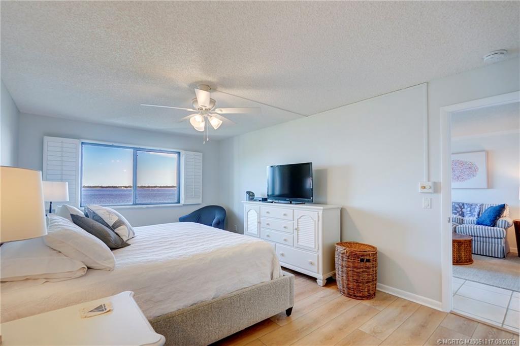 10 Northeast Plantation Road, Unit 203 Stuart, FL 34996 - Photo 45 of 50 a bedroom with a bed and a flat screen tv