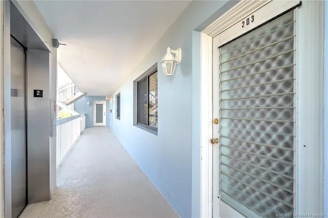 a view of a hallway with wooden shelves