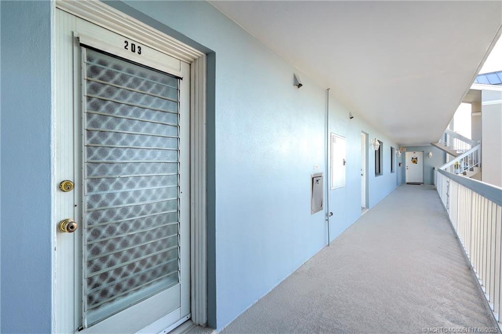 10 Northeast Plantation Road, Unit 203 Stuart, FL 34996 - Photo 7 of 50 a view of a hallway with wooden shelves
