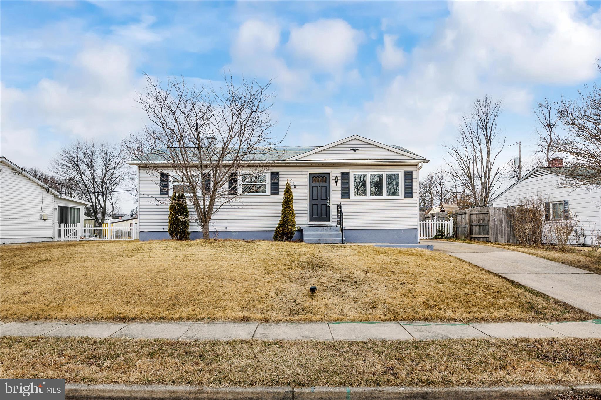 a front view of a house with a yard covered in snow