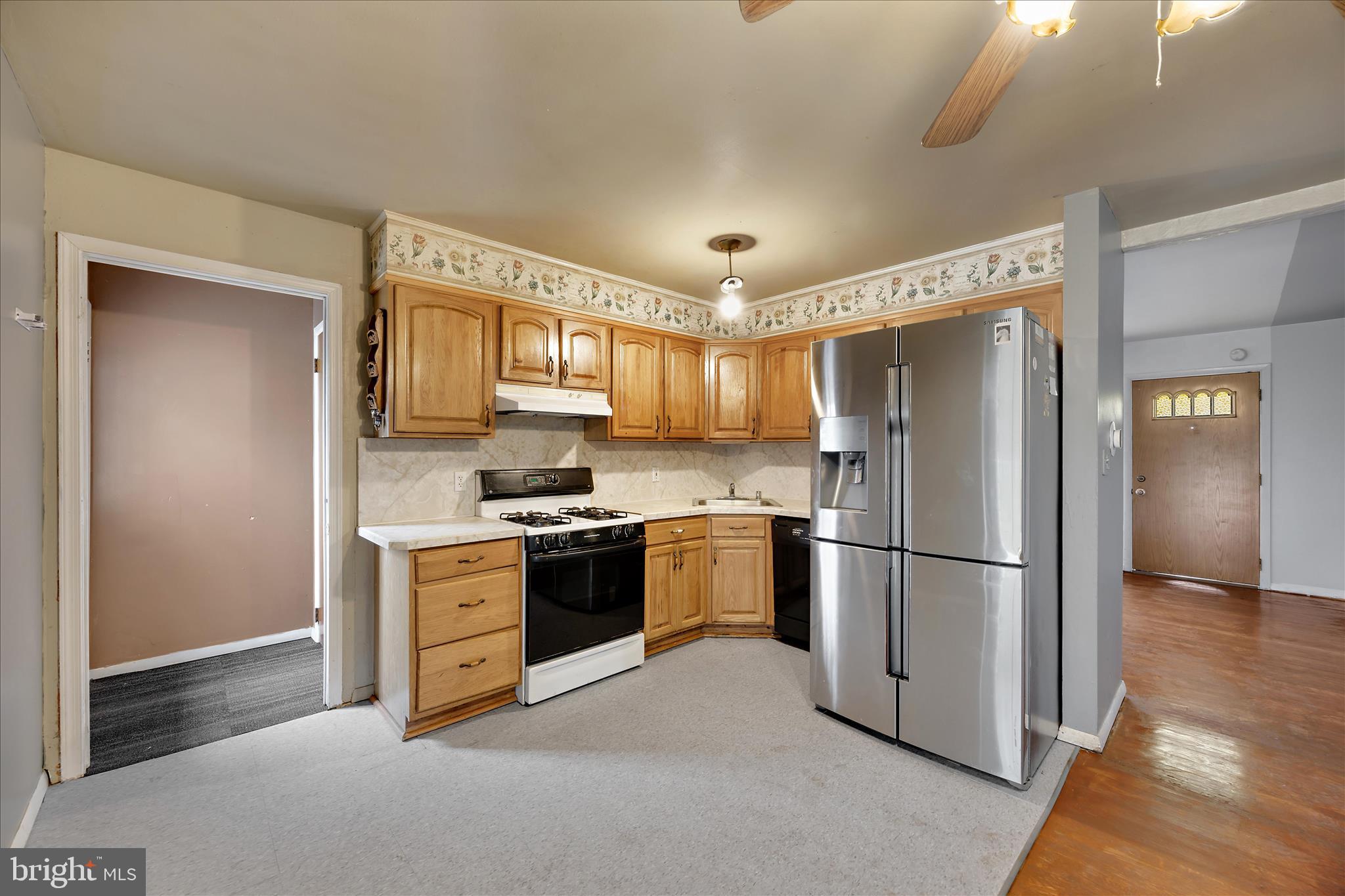 518 Kintop Road Glen Burnie, MD 21061 - Photo 6 of 33 a kitchen with stainless steel appliances granite countertop a refrigerator a stove a sink and a microwave