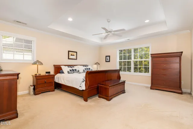 a spacious bedroom with a bed and a dresser