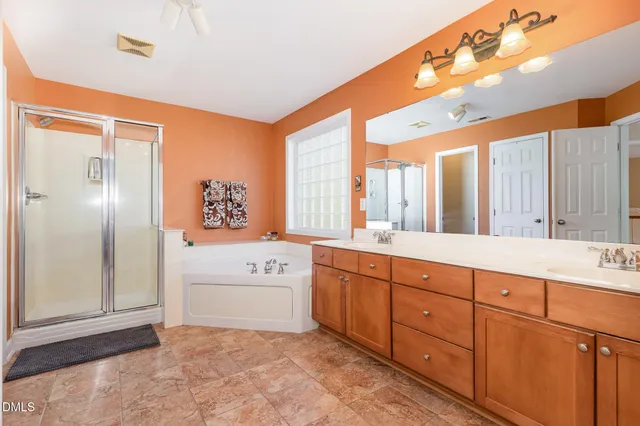 a spacious bathroom with a sink mirror and a bathtub