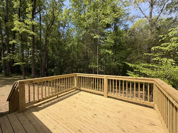 a view of balcony with wooden floor and fence