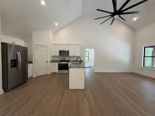 a kitchen with stainless steel appliances a refrigerator and a stove top oven