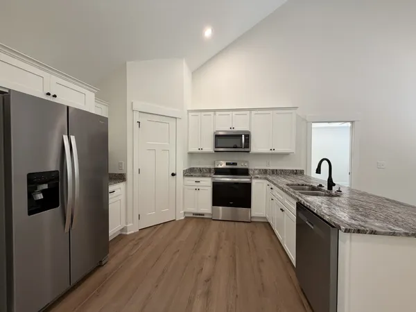 a kitchen with stainless steel appliances a refrigerator stove and sink