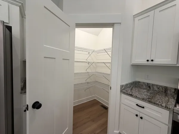 a bathroom with a granite countertop sink and a window