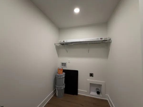 a view of storage and utility room with closet
